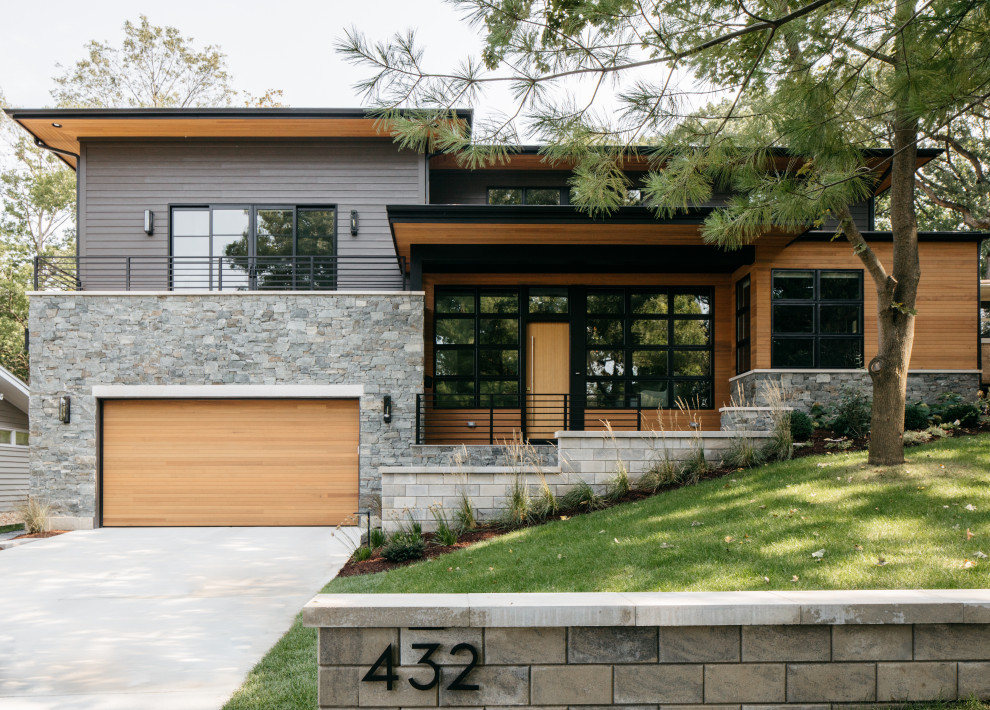 This is an example of a contemporary two floor detached house in Chicago with mixed cladding and a hip roof.