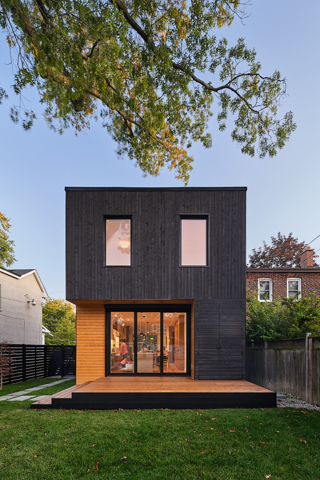 Photo of a black scandinavian detached house in Vancouver with wood cladding.