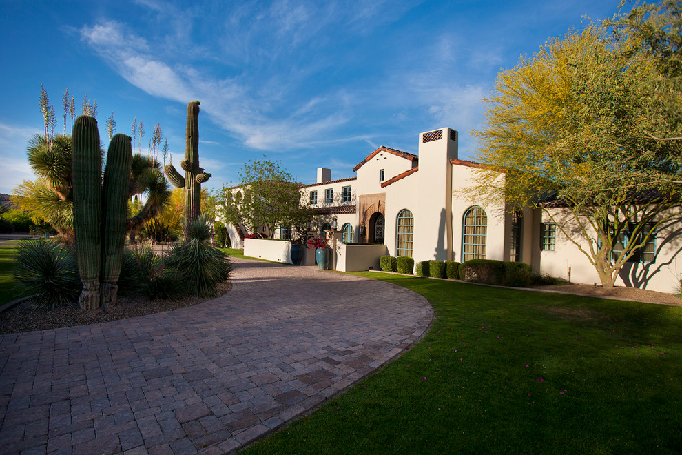 Example of a large tuscan white two-story stucco gable roof design in Phoenix