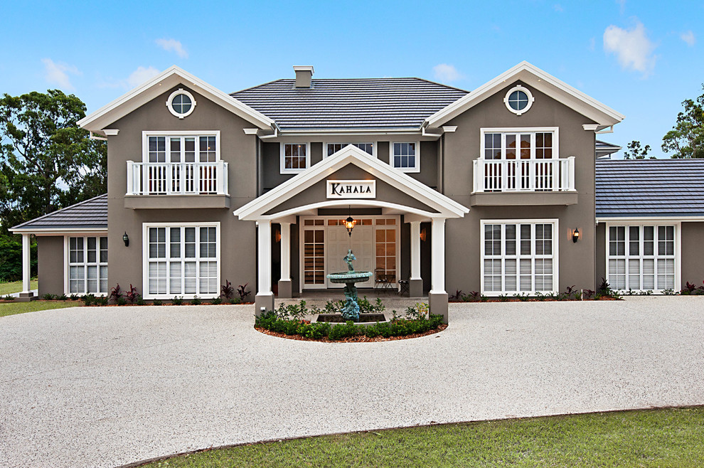 Example of a huge classic gray two-story brick exterior home design in Brisbane with a metal roof