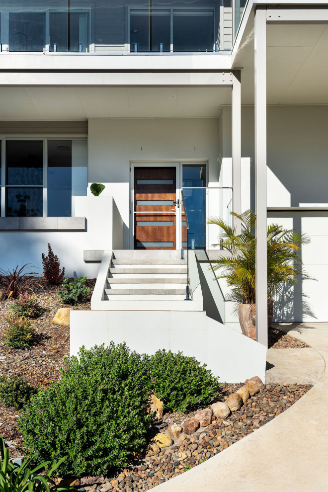 Zweistöckiges Maritimes Einfamilienhaus mit gestrichenen Ziegeln, weißer Fassadenfarbe und Blechdach in Central Coast