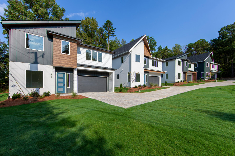 Example of a mid-sized trendy multicolored two-story concrete fiberboard house exterior design in Charlotte with a shingle roof