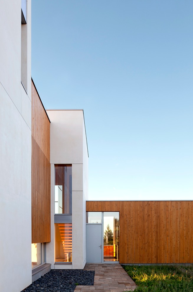 This is an example of a contemporary house exterior in Portland with wood cladding.