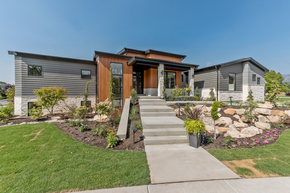 Inspiration for a large and gey contemporary bungalow front detached house in Salt Lake City with mixed cladding, a pitched roof and a shingle roof.