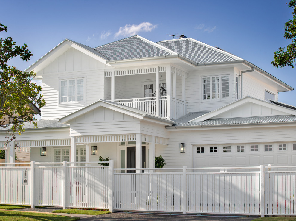 Inspiration for a large and white beach style two floor detached house in Brisbane with concrete fibreboard cladding, a pitched roof and a metal roof.