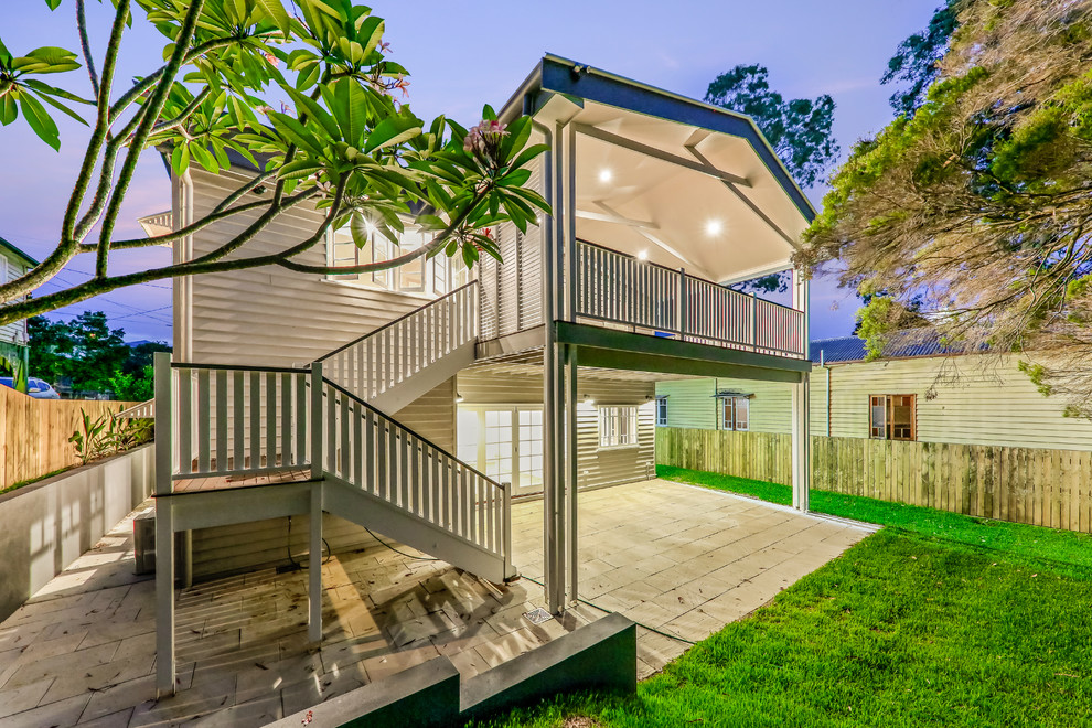 Gey classic two floor house exterior in Brisbane with wood cladding and a pitched roof.