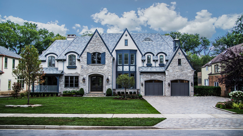 Huge elegant gray three-story stone exterior home photo in Chicago
