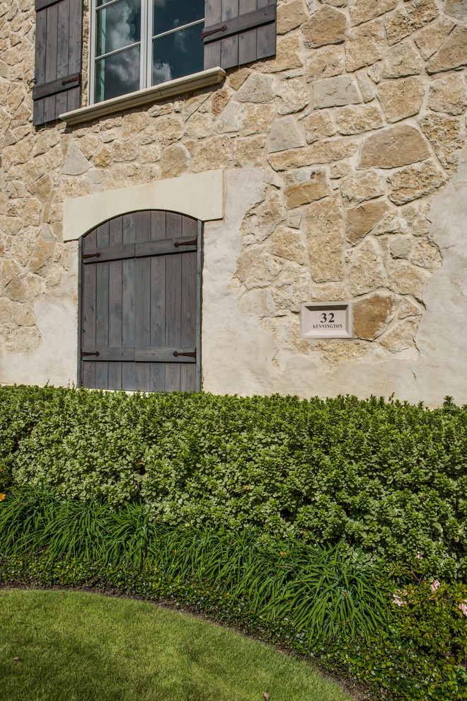 Esempio della facciata di una casa beige contemporanea con rivestimento in pietra