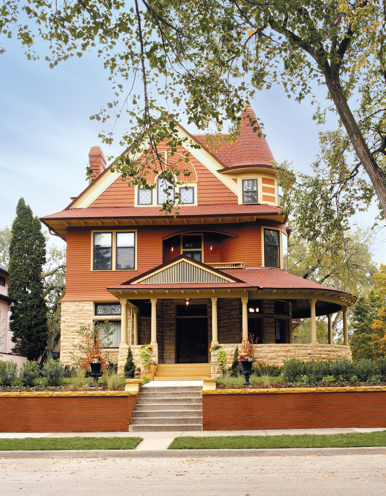 Traditional brown three-story mixed siding exterior home idea in Minneapolis