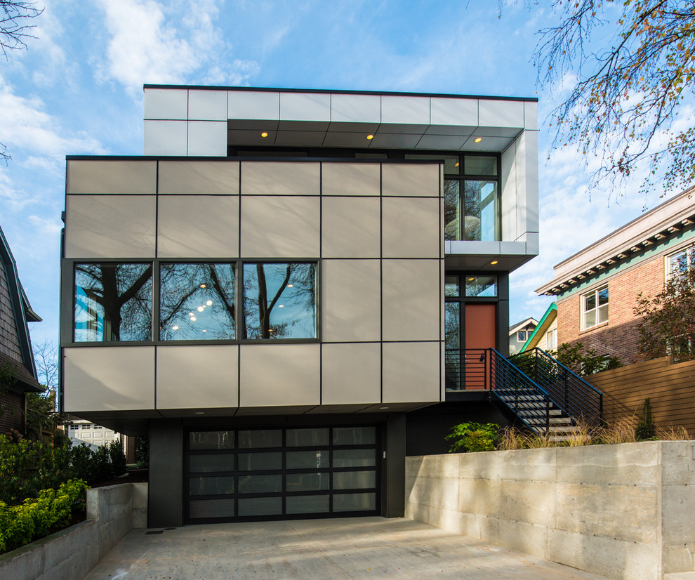 Example of a large minimalist multicolored three-story metal flat roof design in Seattle