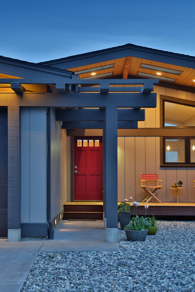 Inspiration for a medium sized and beige retro bungalow house exterior in Seattle with wood cladding and a hip roof.