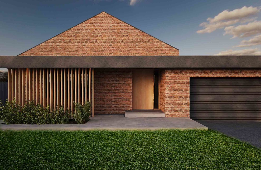 Cette image montre une façade de maison rouge minimaliste en brique de taille moyenne et de plain-pied avec un toit à deux pans et un toit en tuile.