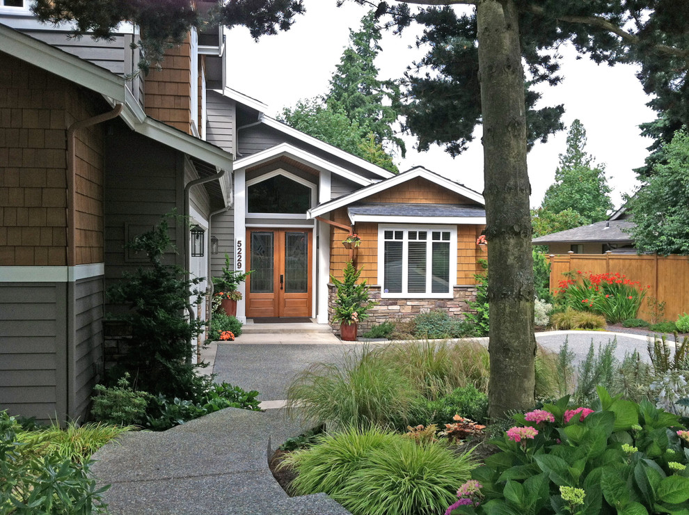 Example of a mid-sized arts and crafts brown two-story wood house exterior design in Seattle with a hip roof and a shingle roof