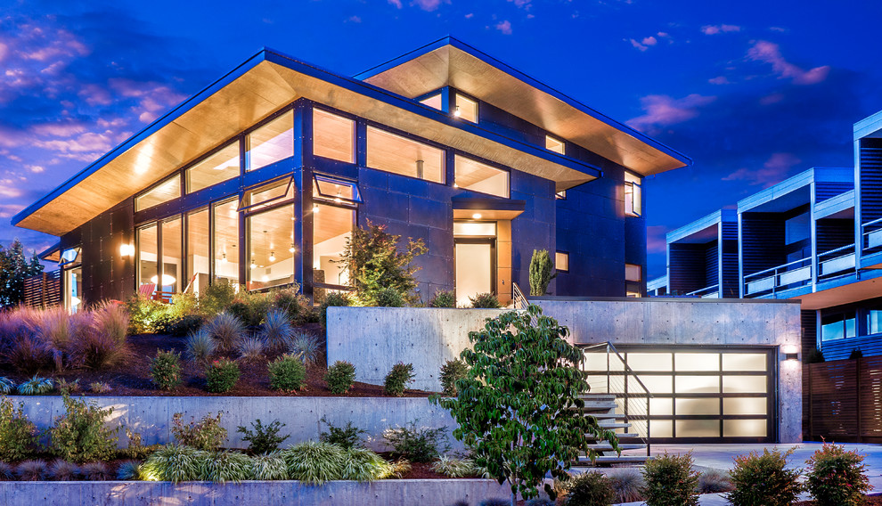 Mid-sized trendy gray two-story concrete fiberboard house exterior photo in Seattle with a hip roof