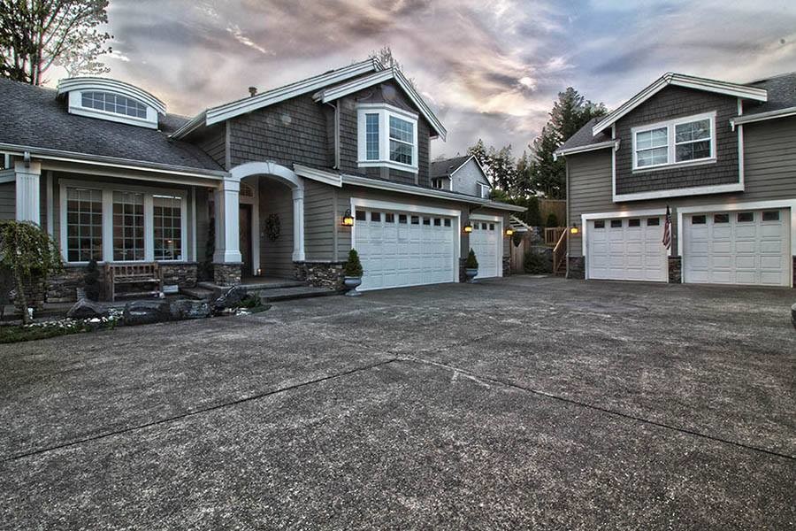 Inspiration for a large and gey classic house exterior in Seattle with wood cladding and a pitched roof.