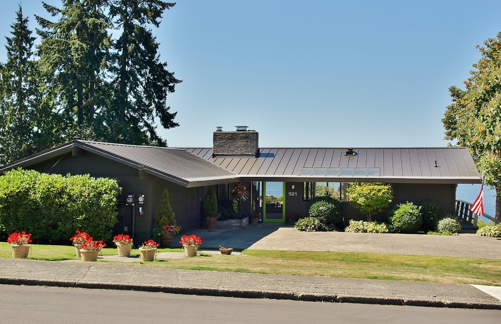 This is an example of a medium sized and brown midcentury bungalow house exterior in Seattle with wood cladding and a pitched roof.