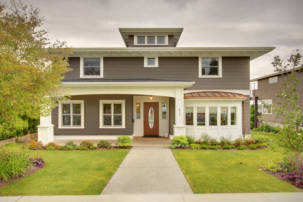 Photo of a medium sized traditional house exterior in Seattle with three floors and wood cladding.