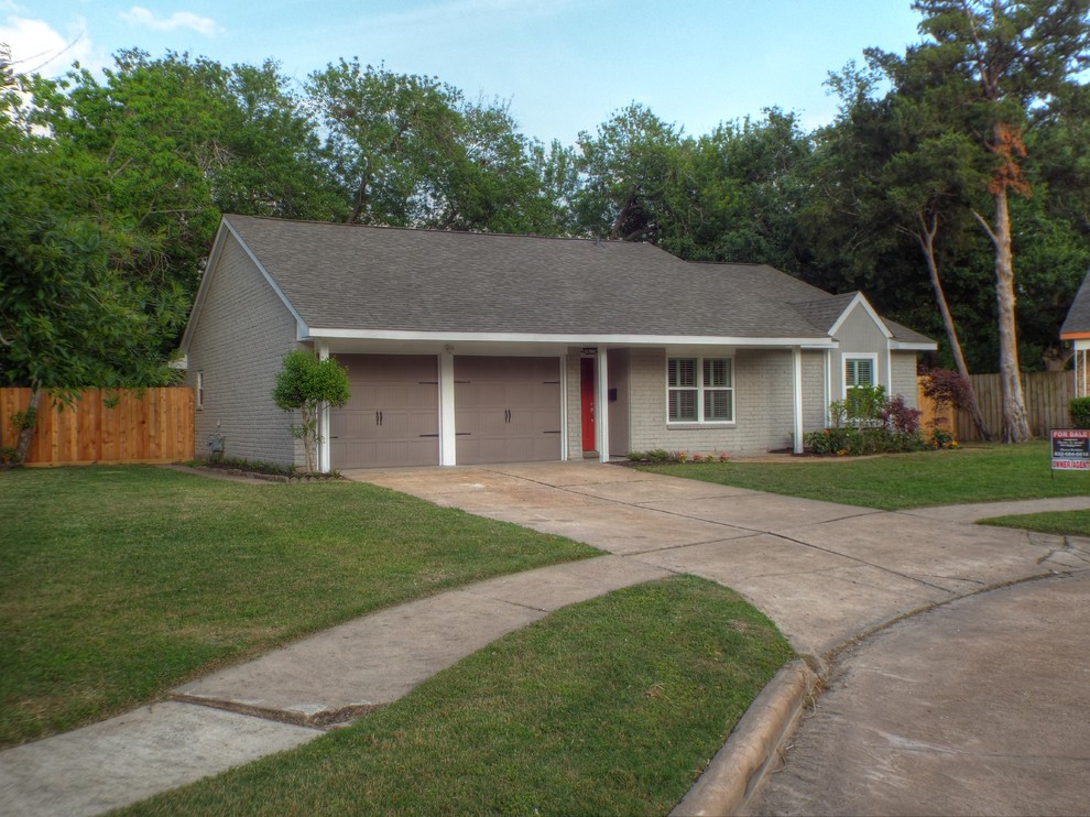 This is an example of a medium sized and gey classic bungalow detached house in Houston with wood cladding, a pitched roof and a shingle roof.