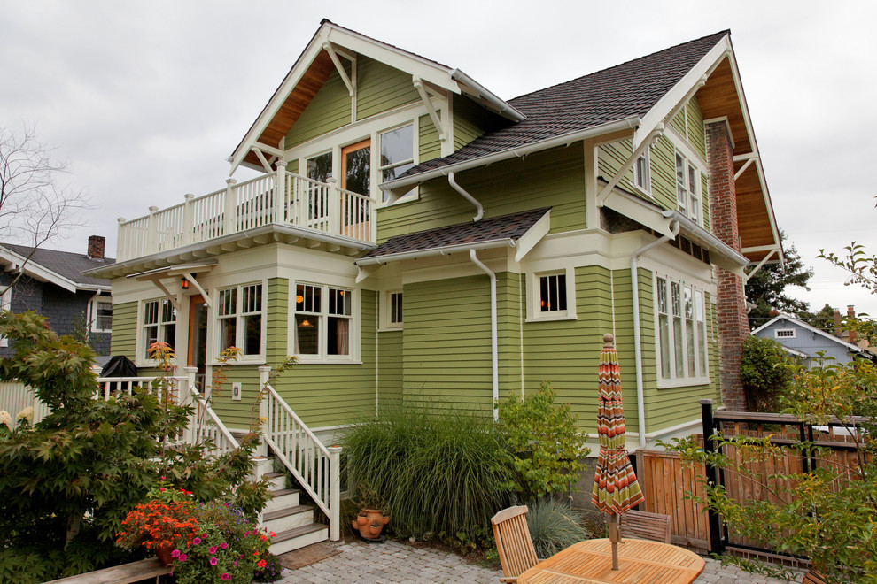 Mid-sized arts and crafts green two-story wood gable roof photo in Seattle