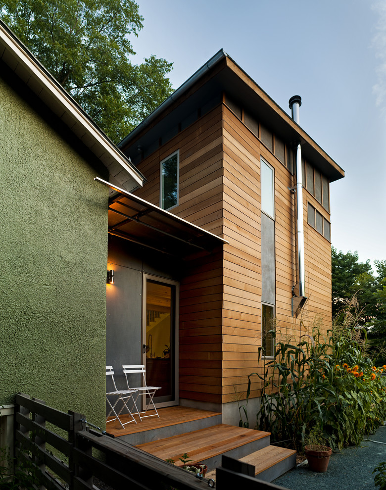 Immagine della facciata di una casa verde moderna a due piani con rivestimenti misti