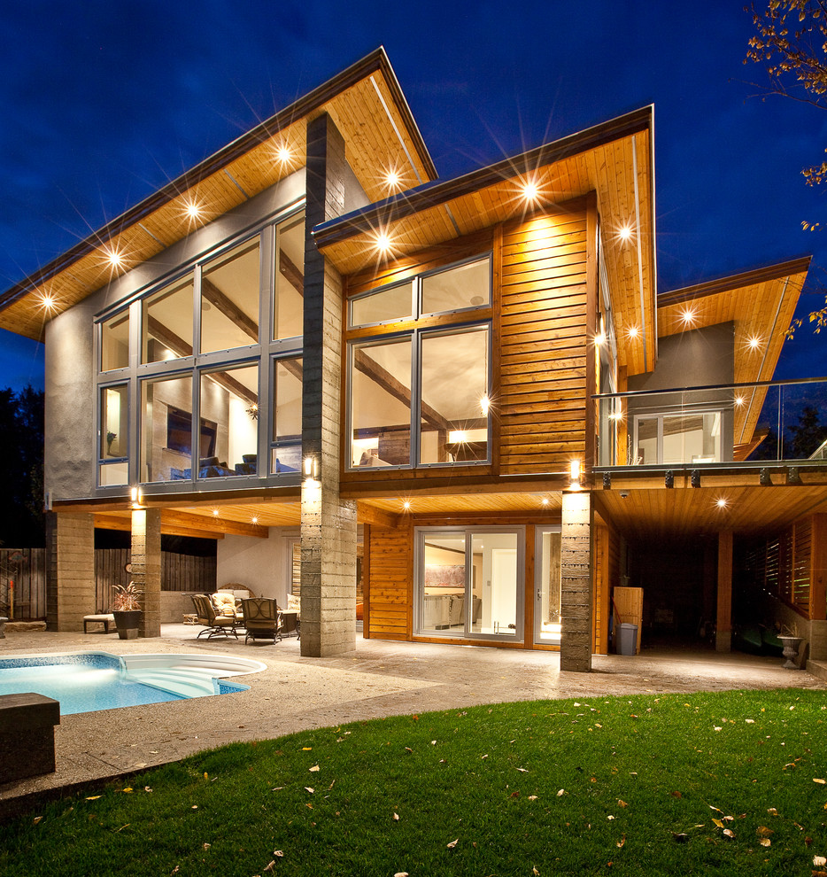 Inspiration for a contemporary brown two-story mixed siding flat roof remodel in Vancouver