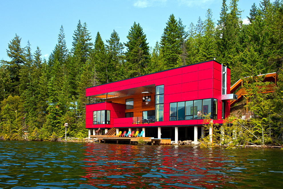 Red contemporary detached house in Calgary with a flat roof.