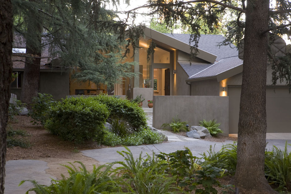 Inspiration for a large contemporary gray one-story stucco exterior home remodel in Los Angeles