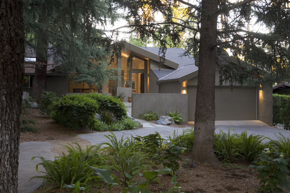 This is an example of a large and gey contemporary bungalow render house exterior in Los Angeles.