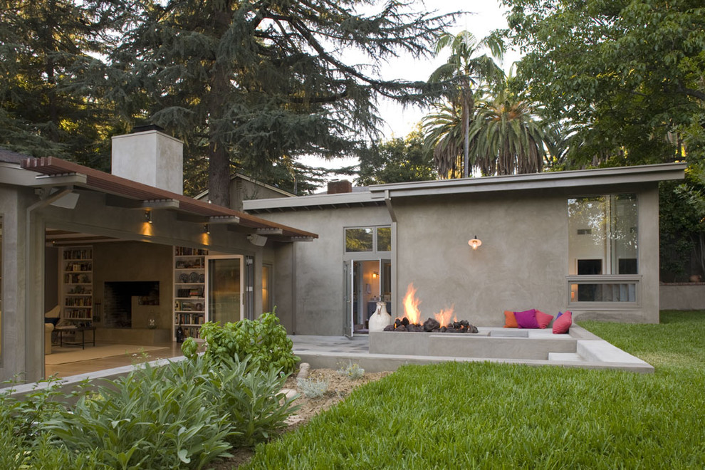 Пример оригинального дизайна: одноэтажный, большой, серый дом в современном стиле с облицовкой из цементной штукатурки и односкатной крышей