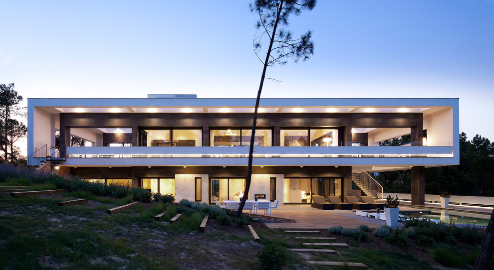 Huge modern white two-story mixed siding flat roof idea in Barcelona