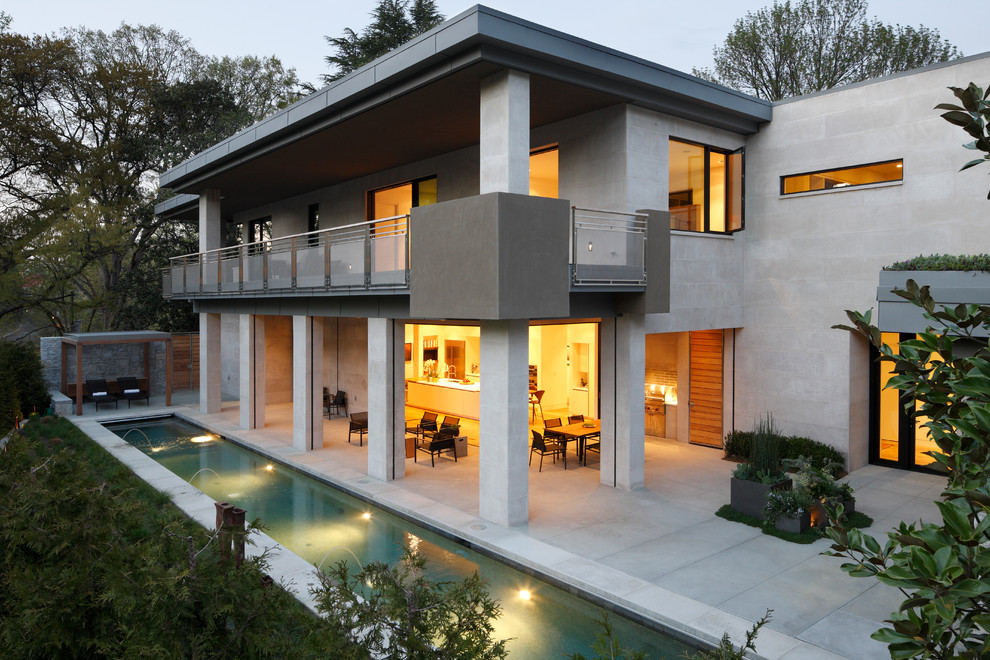 На фото: большой, двухэтажный, бежевый дом в современном стиле с облицовкой из камня с