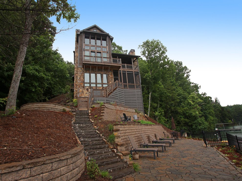 Inspiration for a mid-sized rustic brown three-story stone exterior home remodel in Atlanta