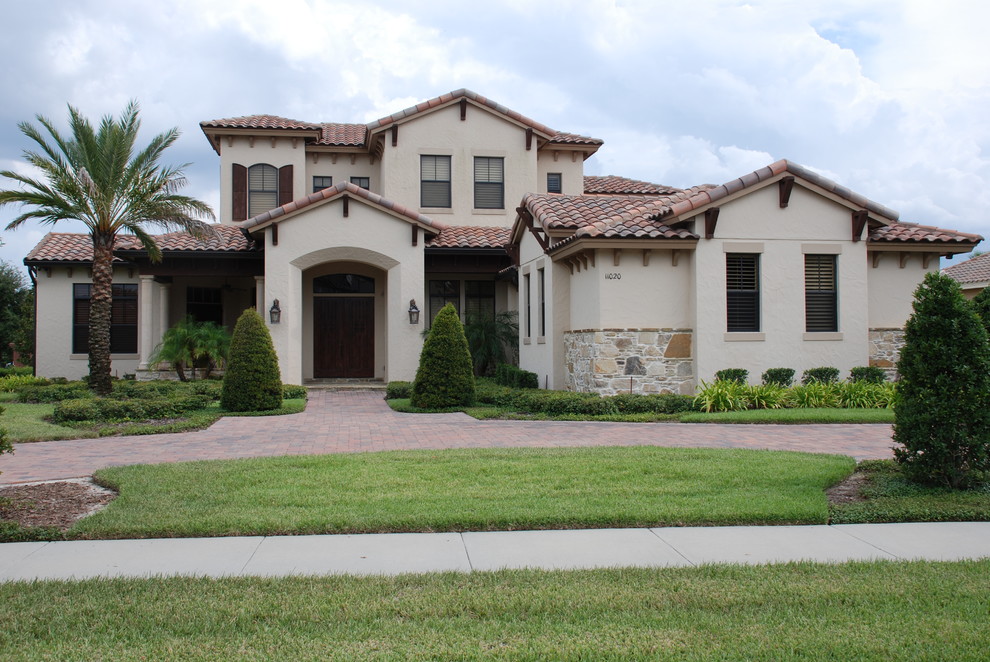Tuscan beige mixed siding gable roof photo in Orlando
