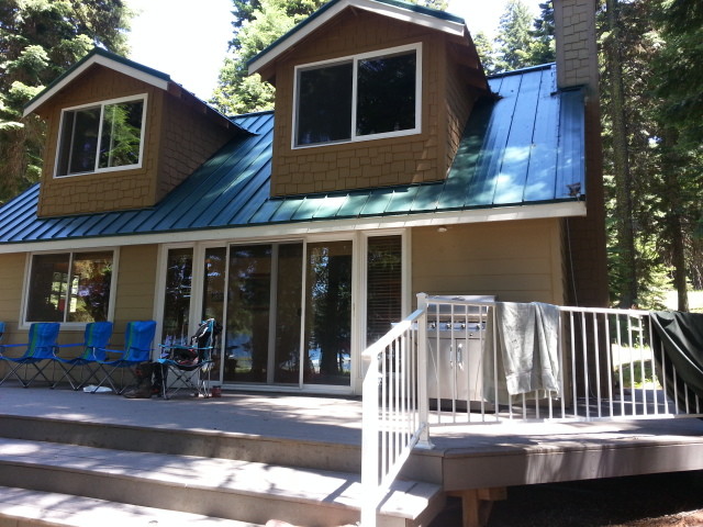 Example of a small mountain style brown split-level concrete gable roof design in Denver