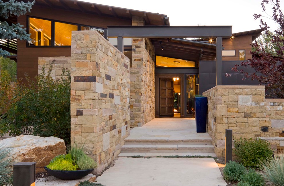 Brown contemporary house exterior in Denver with mixed cladding.