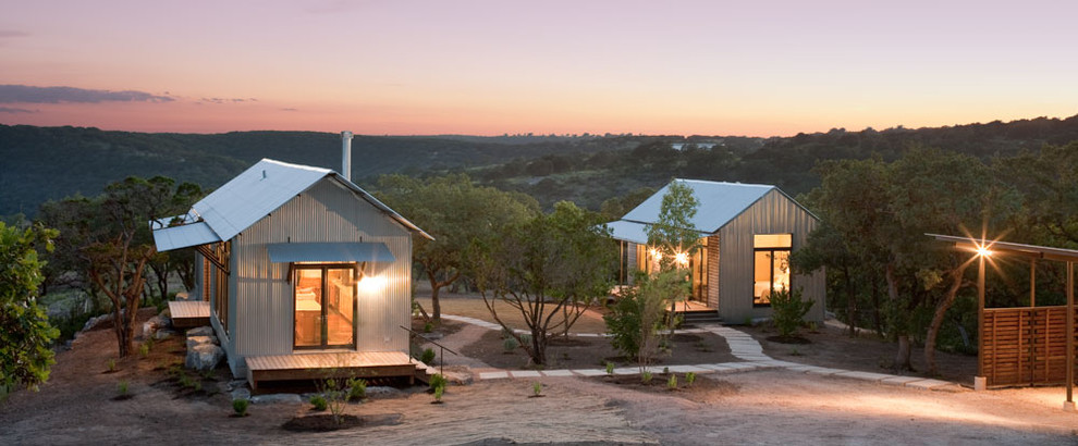 Inspiration for a small rustic bungalow house exterior in Austin with metal cladding.