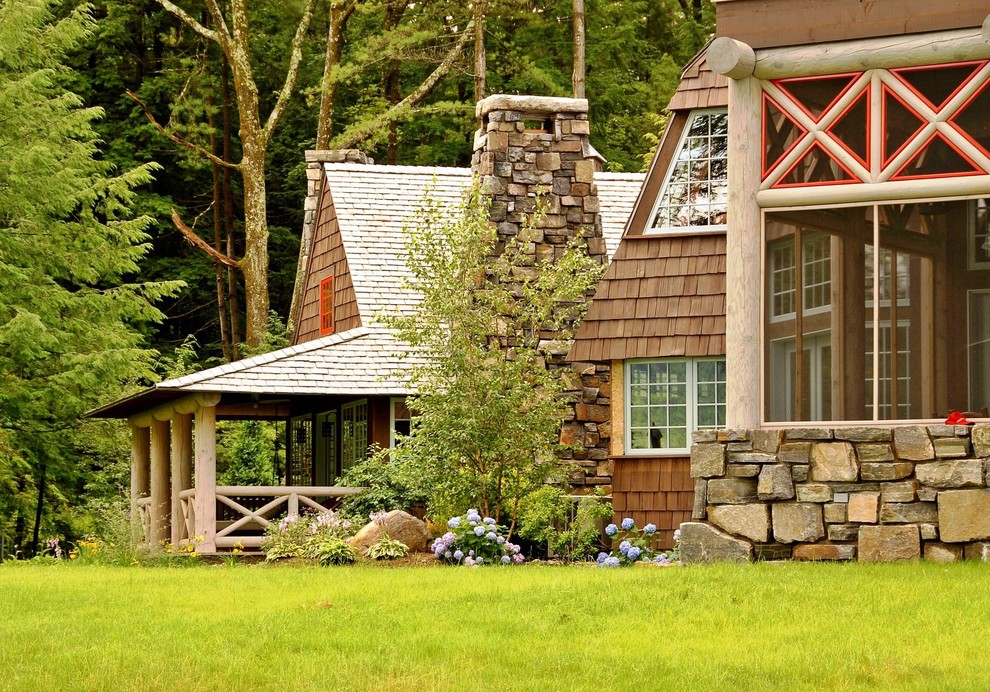 Inspiration for a large rustic brown two-story wood exterior home remodel in New York with a shingle roof