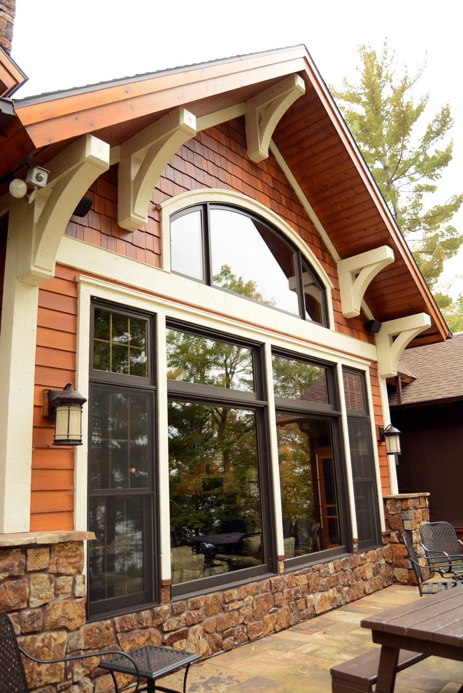 Example of a large mountain style brown three-story wood exterior home design in Minneapolis