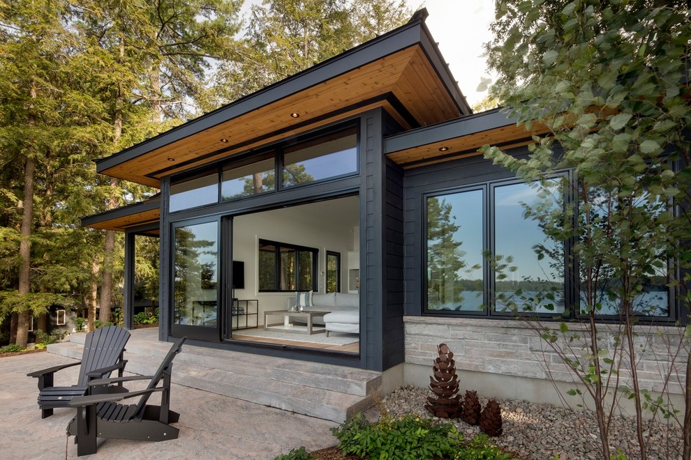 Inspiration for a mid-sized contemporary black one-story mixed siding exterior home remodel in Toronto with a shingle roof