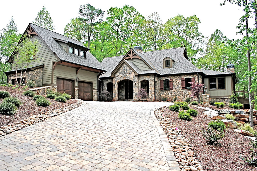 Inspiration for a rustic green split-level mixed siding exterior home remodel in Other with a shingle roof