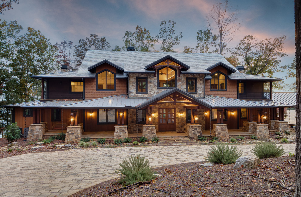 Inspiration for a large rustic two-story mixed siding house exterior remodel in Other with a mixed material roof