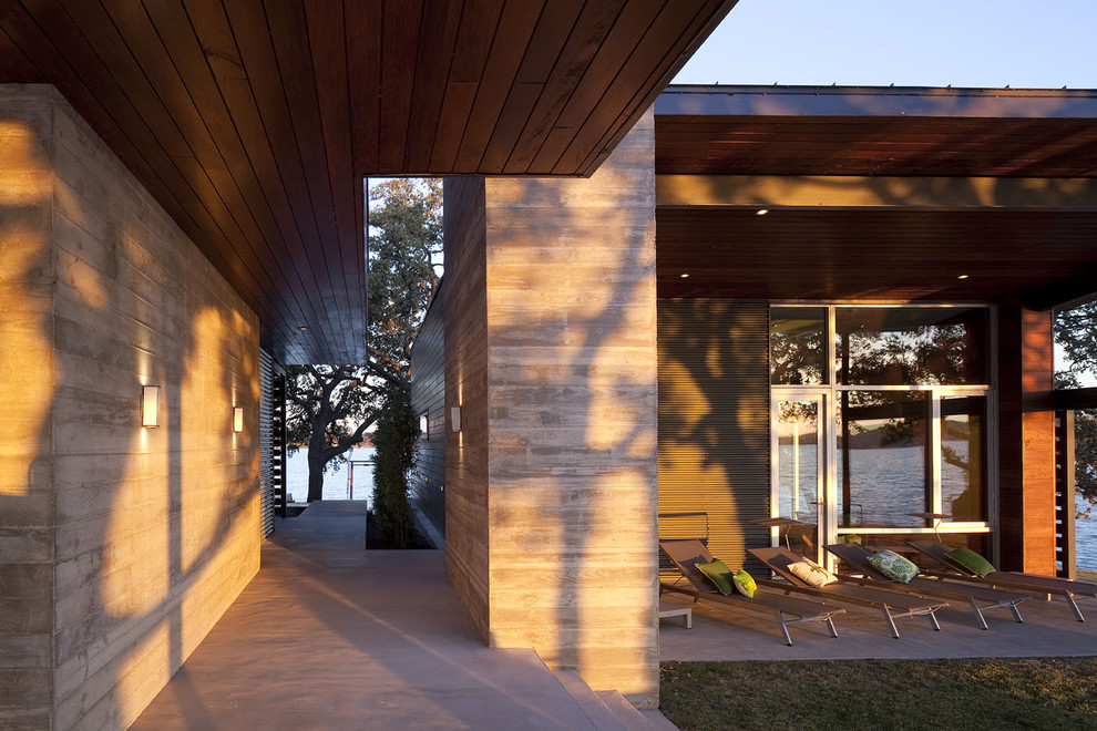 This is an example of a large and multi-coloured contemporary two floor house exterior in Austin with metal cladding and a flat roof.