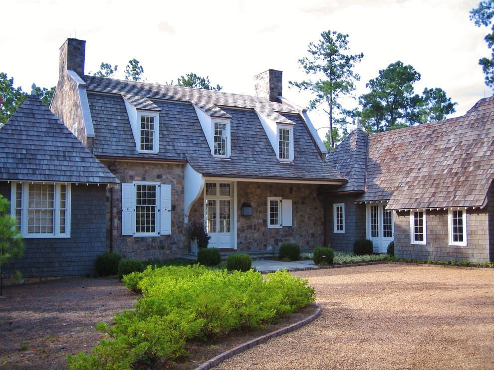 Пример оригинального дизайна: дом в стиле рустика с облицовкой из камня и мансардной крышей