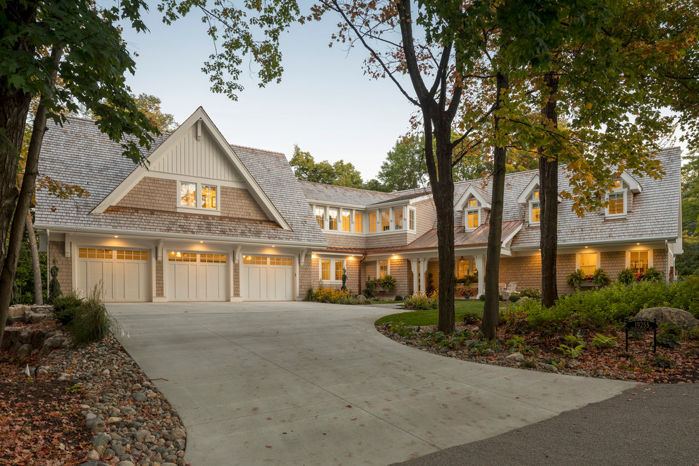 Photo of a medium sized and beige beach style two floor detached house in Minneapolis with wood cladding, a pitched roof and a shingle roof.
