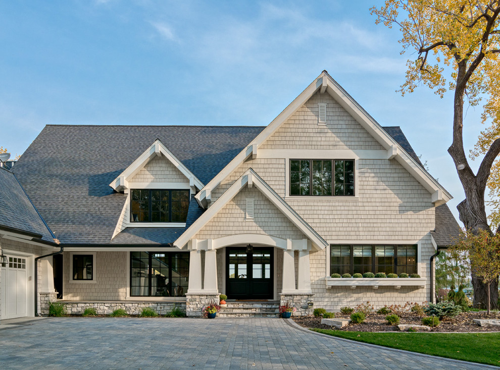 This is an example of a beige classic two floor detached house in Minneapolis with wood cladding, a pitched roof, a shingle roof, a black roof and shingles.