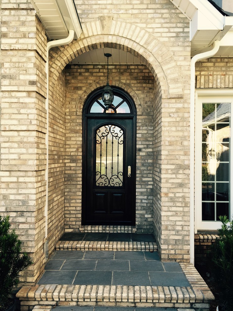 Inspiration for a small and beige traditional two floor brick house exterior in Charlotte.