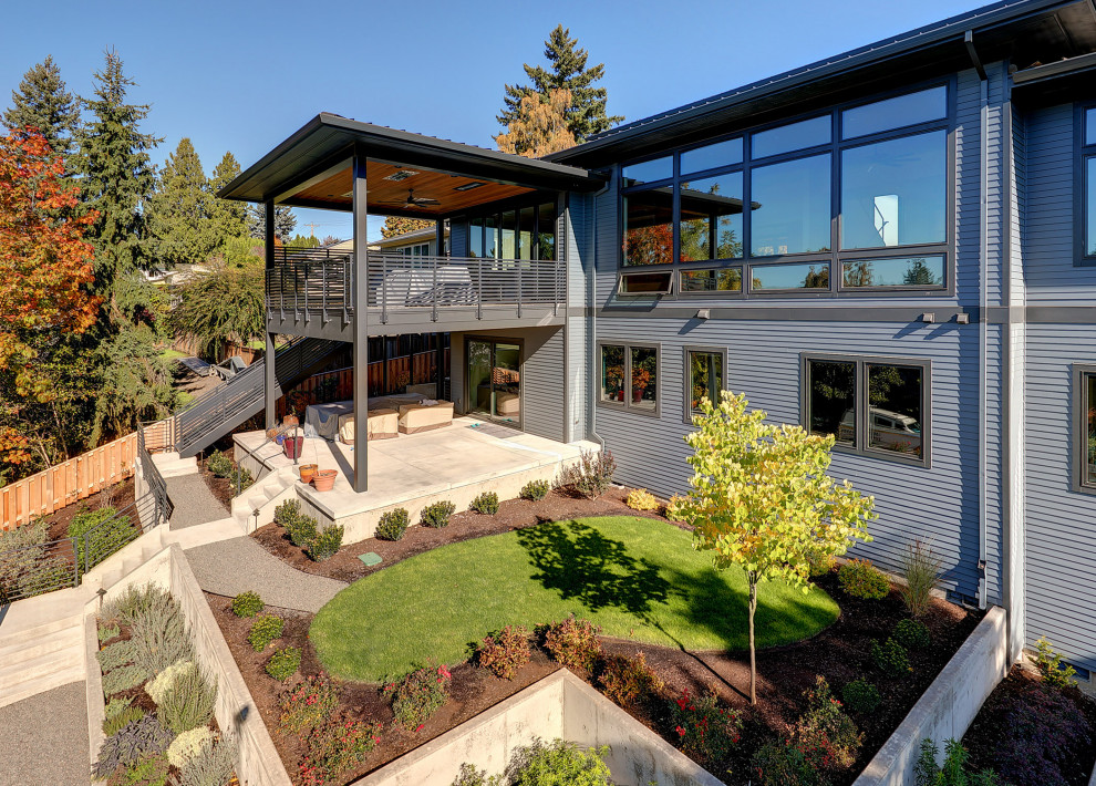 Example of a large trendy gray two-story mixed siding exterior home design in Portland with a metal roof