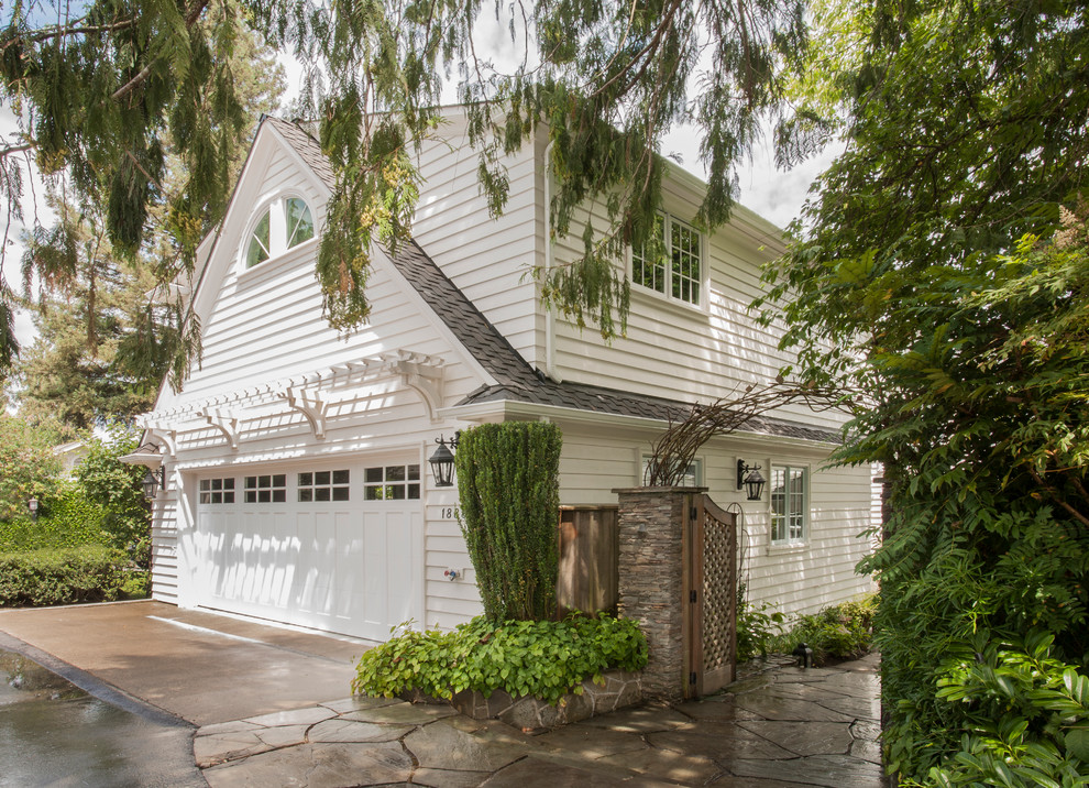 Example of a large classic white one-story wood gable roof design in Seattle