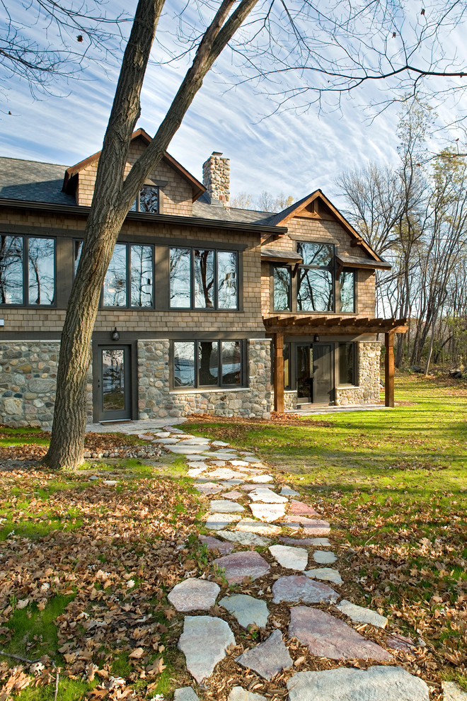 Photo of a rustic two floor house exterior in Minneapolis with mixed cladding.