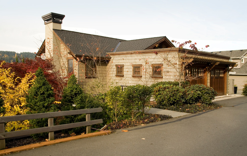 Example of an arts and crafts one-story wood exterior home design in Seattle
